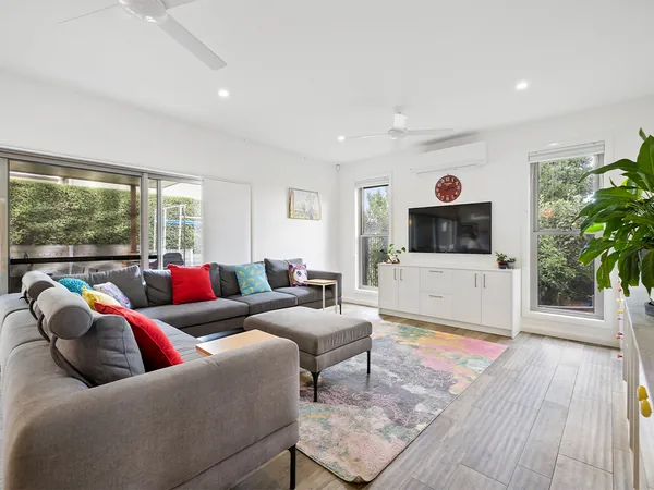 Example photo: a bright family room with sliding doors to an alfresco